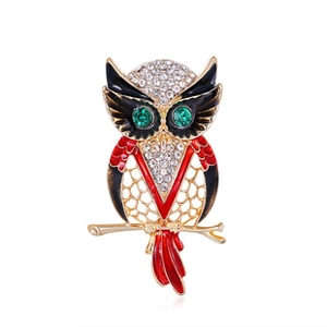 Detailed close-up of a vintage owl brooch with sparkling crystals and colorful enamel