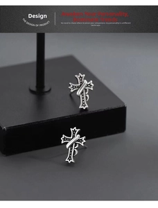 Macro detail of 925 sterling silver cross stud earring with vintage embossed finish