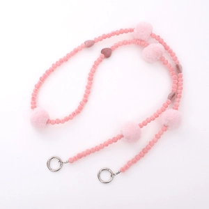 Pink beaded phone lanyard with plush pom-poms and metal clasps on white background