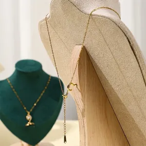 Solid wood bust jewelry stand showcasing a gold necklace with adjustable lobster clasp