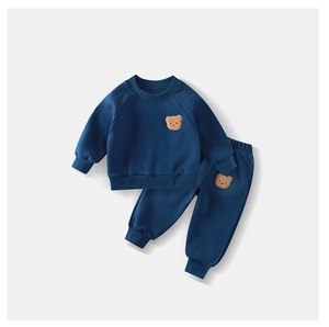 Detail of navy blue fleece tracksuit with cute 3D brown teddy bear patch decoration