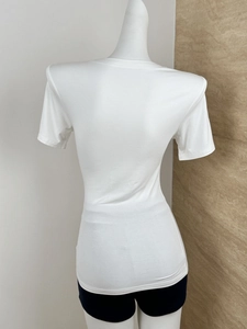 Rear view of white slim-fit T-shirt showing structural shoulder pads on a mannequin