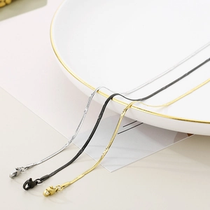 Detailed view of 1.5mm snake chains in silver, black and gold finishes with lobster clasp