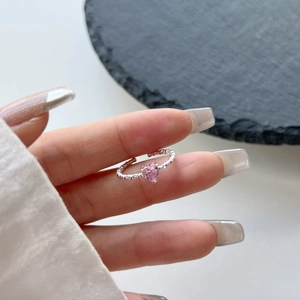 Detailed macro view of pink heart zircon ring with adjustable silver rope band