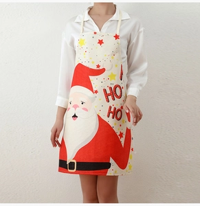 Detail of Christmas apron featuring a printed Santa Claus pattern and Ho Ho text