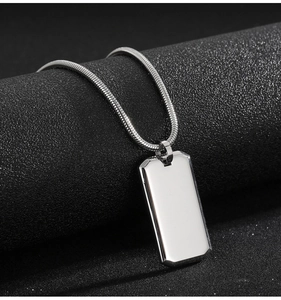 Macro shot of silver mirror polished stainless steel dog tag on a snake chain