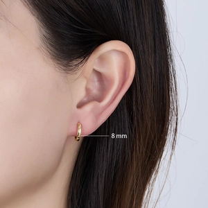 Close-up of 8mm gold minimalist hoop earring on ear showing scale and polished finish
