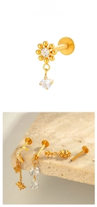 Detailed view of F136 titanium gold labret studs with zircon moon and star charms