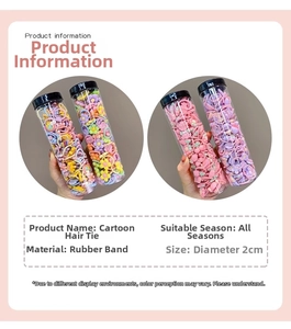 Detail view of 2cm mini cartoon elastic hair bands set in a clear storage cylinder