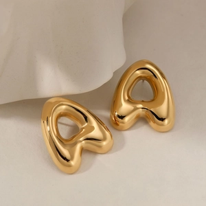 Minimalist gold letter stud earrings with polished mirror finish on artistic stone base