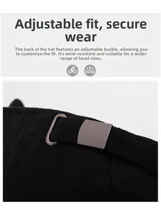 Detail of the adjustable metal buckle and thick textured fabric on a black winter cap