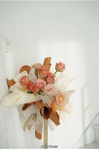 Detail view of multi-colored roses wrapped in elegant French-style pleated pearl tulle gauze