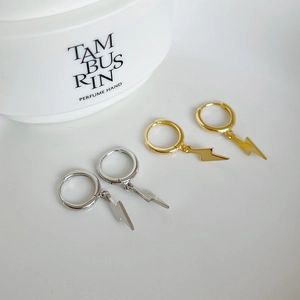 Detailed view of silver and gold lightning bolt earrings with S925 sterling silver stamp