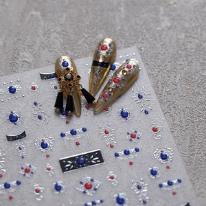 Baroque style embossed nail stickers with silver foil patterns and faux gemstones