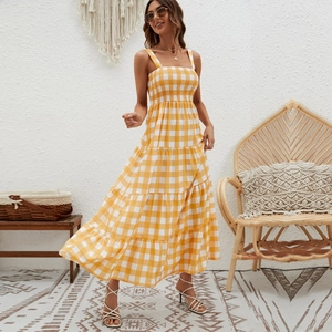 Detail of yellow and white plaid dress with smocked bodice and tiered bohemian skirt