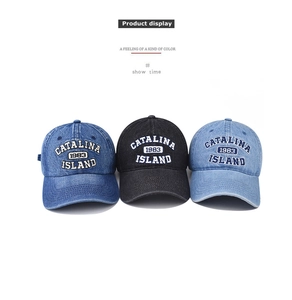 Detailed view of three vintage washed denim baseball caps with 1983 embroidery on white base