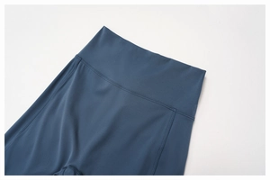 Detail of high-waist yoga pants showing reinforced stitching and matte elastic fabric