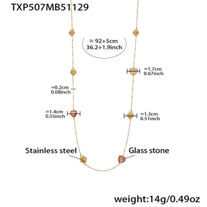Detailed view of long gold stainless steel necklace with pink glass heart charms