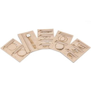 Macro detail of beige travel jewelry organizer showing multi-layer transparent zipper bags