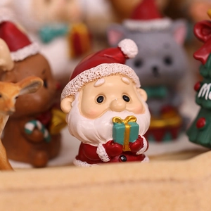 Cute resin Santa Claus ornament holding gift box for Christmas tree and festive decoration