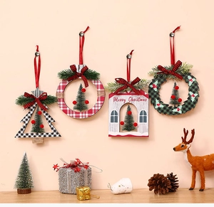 Close-up of four rustic wooden Christmas ornaments with plaid ribbons and pine accents