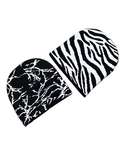 Detailed knit texture of black and white butterfly style beanies for winter fashion