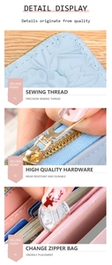 Detailed close-up of light blue leather wallet with precision stitching and metal hardware