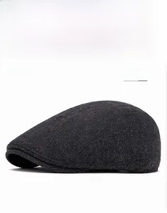 Detailed view of the dark gray wool flat cap showing premium textured knit fabric