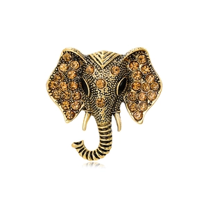 Vintage elephant head brooch in antique gold finish with champagne crystal inlay and reflex