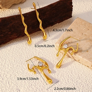 Detailed view of 18K gold plated earrings with zircon insets and wave-shaped metal texture