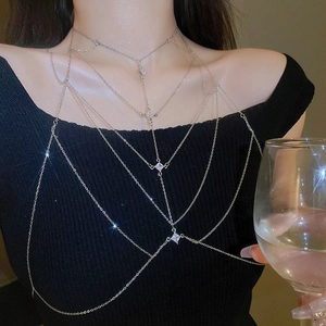 Detail of silver multi-layer body chain with four sparkling rhombus zircon crystals