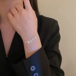 Elegant gold plated adjustable bracelet with seven sparkling cubic zirconia stones