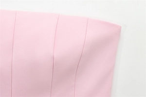 Close-up of pink strapless top showing high-quality woven fabric and precise stitching detail