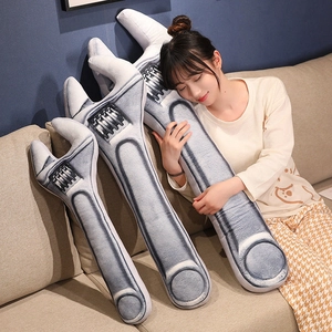 Creative wrench plush pillows in three sizes held by a woman on a cozy home sofa