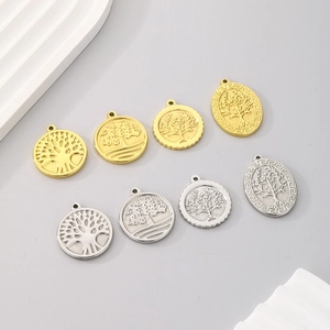 Collection of circular and oval Tree of Life pendants in gold and silver stainless steel