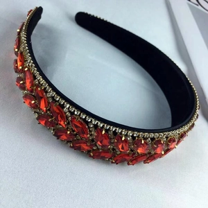 Baroque style wide headband with sparkling red rhinestones and gold accents on white
