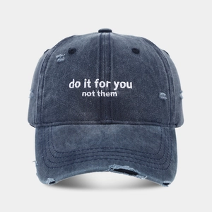 Vintage navy blue washed denim baseball cap with distressed details and white embroidery