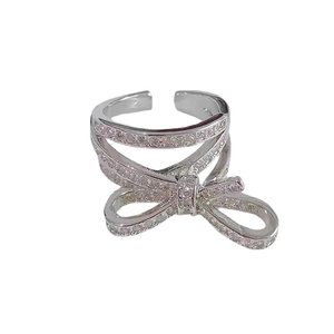 Macro detail of multi-layer silver bow ring with sparkling pavé cubic zirconia