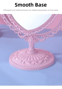 Close-up of pink vintage makeup mirror base featuring intricate floral relief carvings