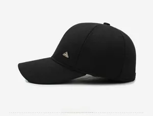 Side view of black baseball cap with twill fabric texture and metal triangle badge