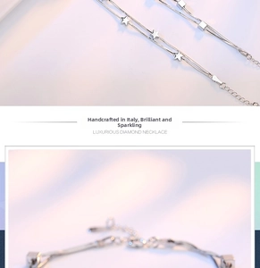 Close-up of double-layer silver snake chain bracelets with star and cube pendants