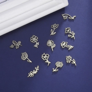 Silver hollow flower pendants in twelve floral shapes for jewelry making on dark blue background
