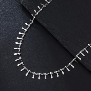 Detailed shot of silver stainless steel chain necklace with textured rectangular pendants