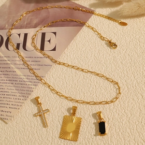 Gold stainless steel necklace featuring cross, sunburst, and black zircon pendants