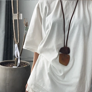 Detailed close-up of Bohemian irregular square resin pendant necklace on leather cord