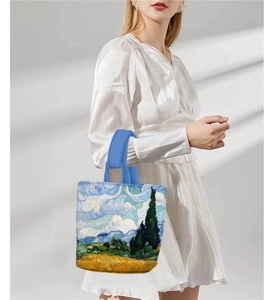 Detail of Van Gogh Wheat Field print on a vintage tote bag with blue handles