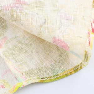 Detail of floral linen fabric showing textured weave and high-quality hemmed edges