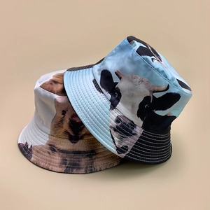 Detail of reversible fisherman hat featuring cow and koala prints with precision stitching