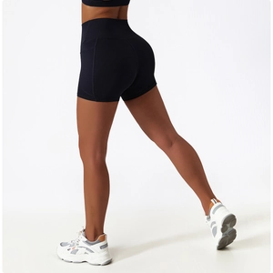 Close-up of high-waisted black yoga shorts showing moisture-wicking fabric and booty lift fit