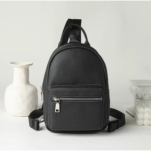 Detail of black lychee grain leather mini bag with silver hardware and nylon strap